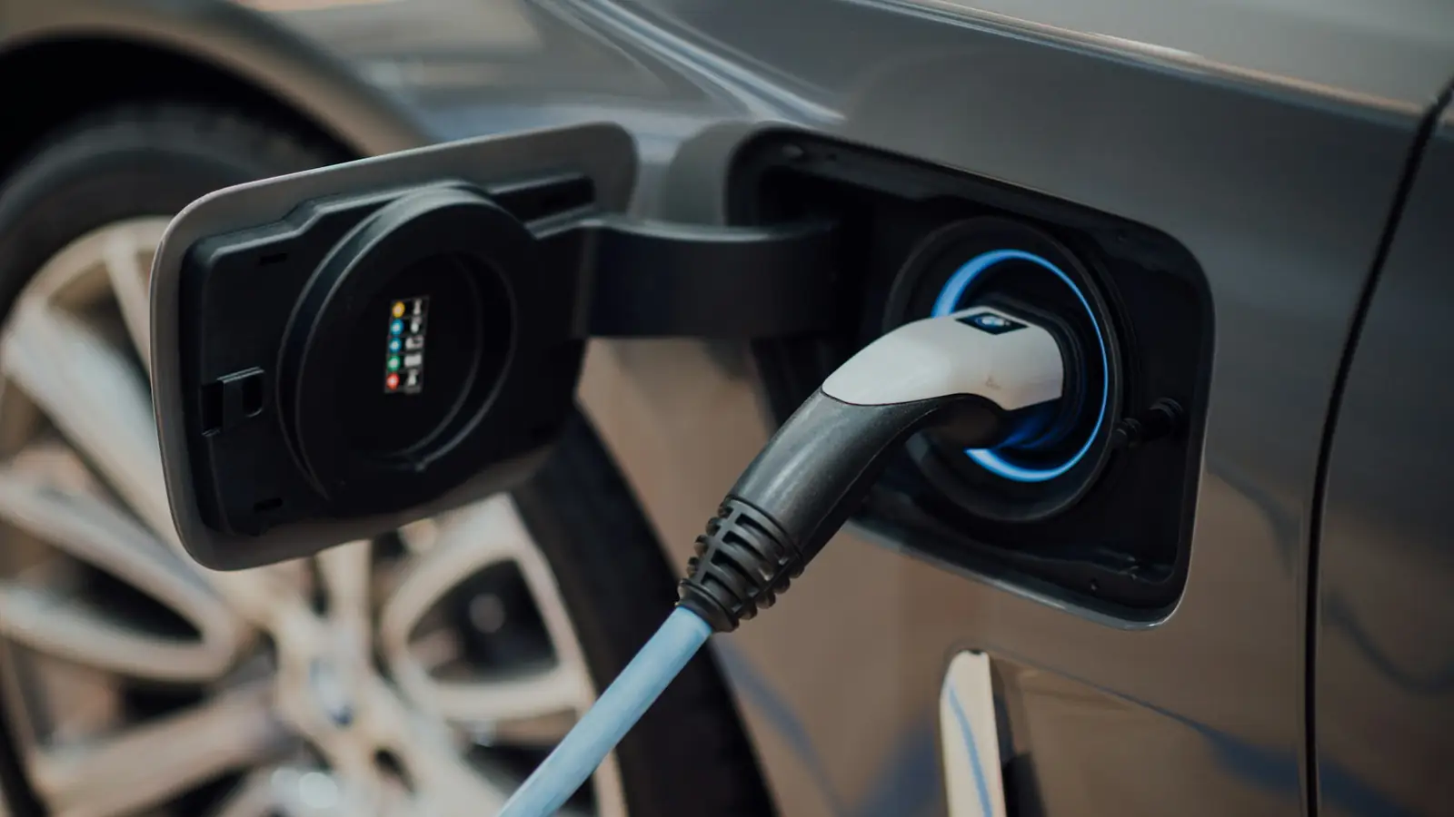 electric vehicle charging cable plugged into car